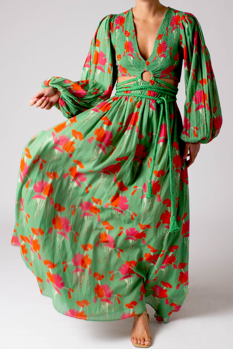 This is a photo of a woman wearing a long green floral dress.