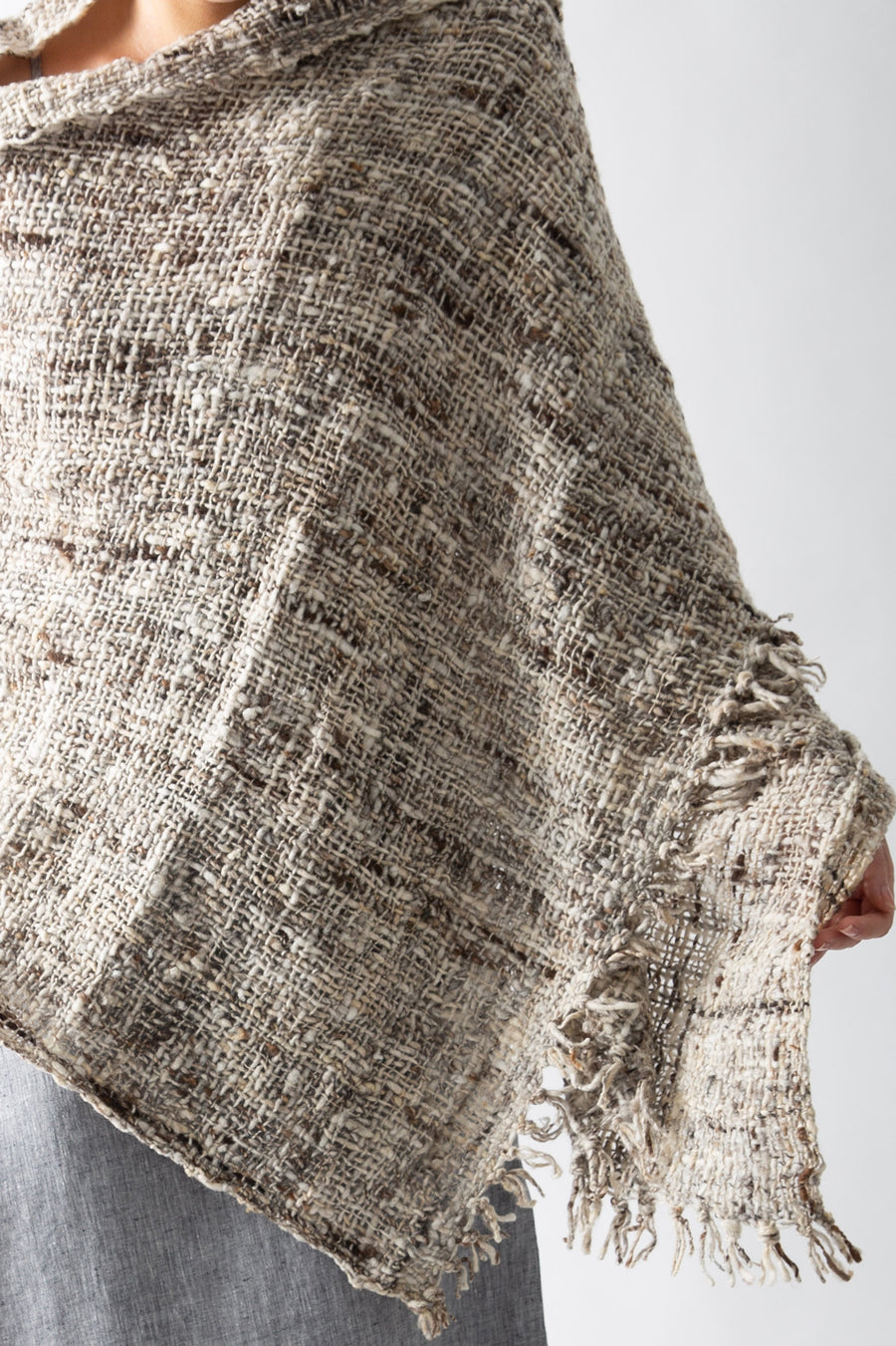 This photo is a close-up on the texture of the shawl, and also features the fringed tassels along the edge.