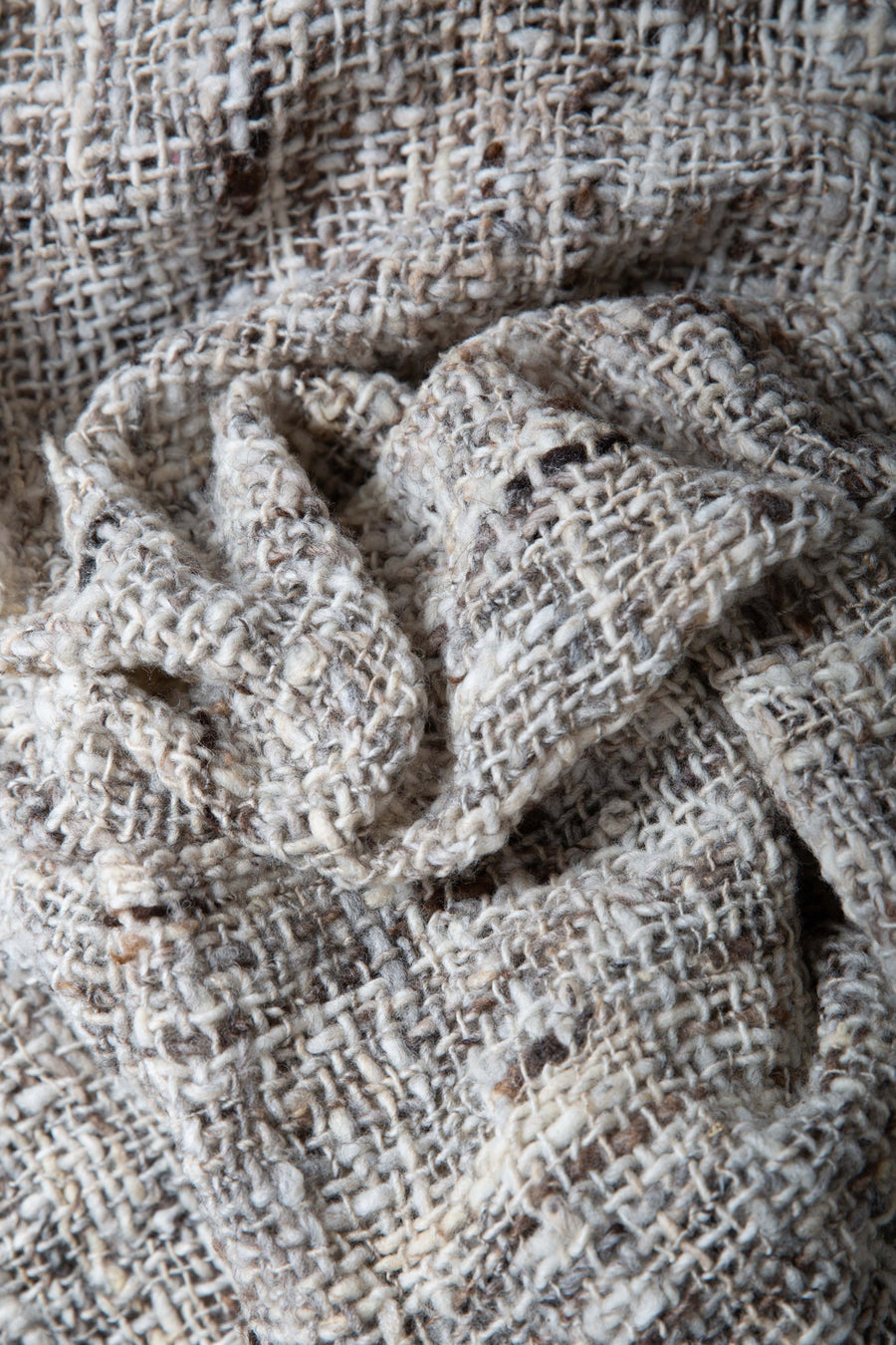 This is a close-up on just the woven shawl, showing the detailed texture of the weave. Each thread is a unique color and thickness.