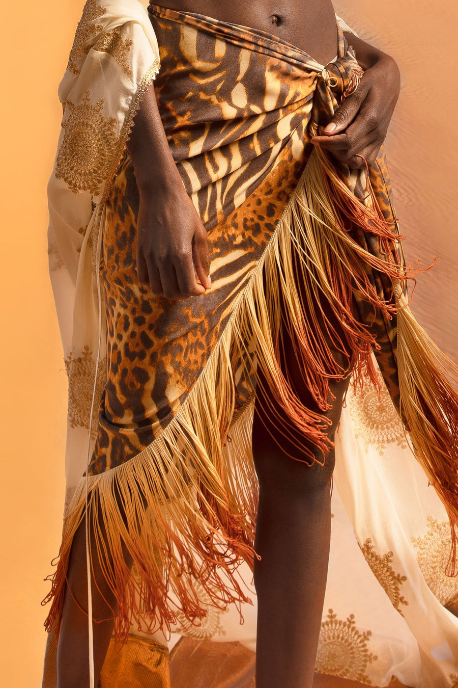 This is a detail photo of a silk cheetah printed pareo with ombre fringe on the hemline.